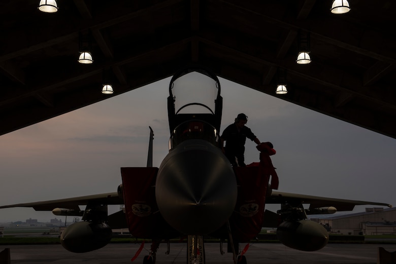 An 18th Aircraft Maintenance Squadron crew chief prepares a 67th Fighter Squadron F-15C Eagle for a mission at Kadena Air Base, Japan, Sept. 16, 2019.