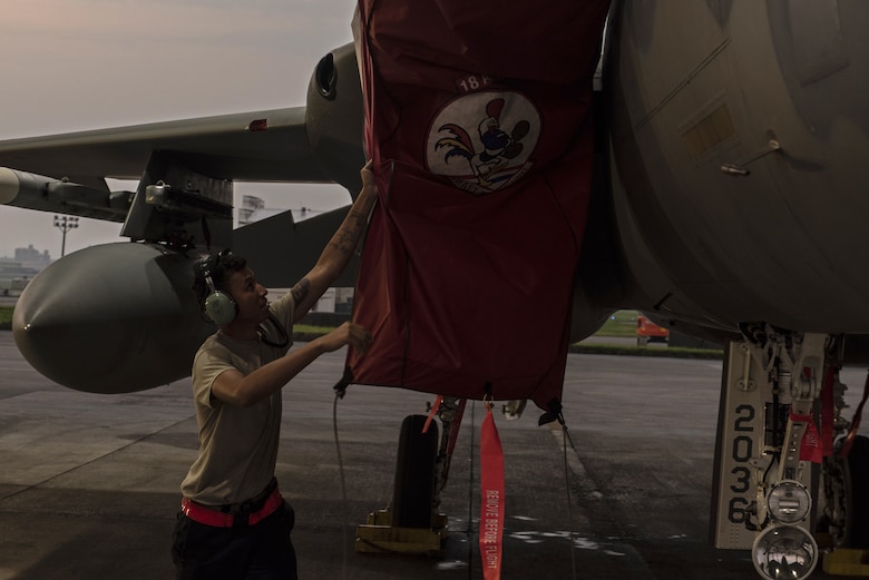 An 18th Aircraft Maintenance Squadron crew chief prepares a 67th Fighter Squadron F-15C Eagle for a mission at Kadena Air Base, Japan, Sept. 16, 2019.