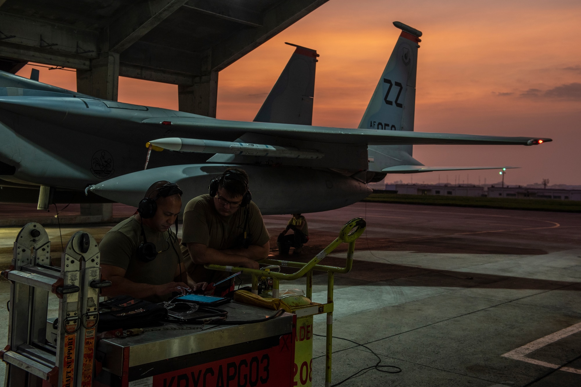 Crew chiefs assigned to the 18th Aircraft Maintenance Squadron discuss the preparation requirements for a 67th Fighter Squadron F-15C Eagle before a mission at Kadena Air Base, Japan, Sept. 16, 2019.