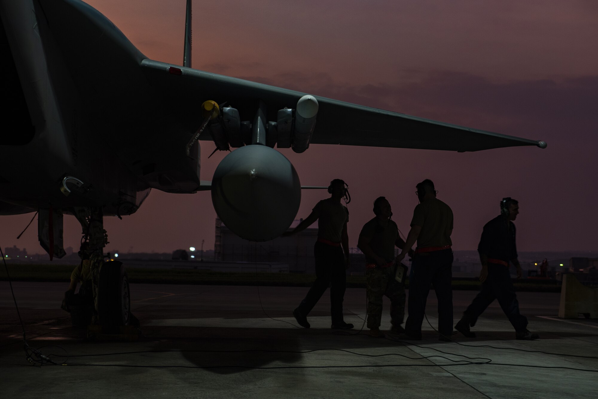 Crew chiefs assigned to the 18th Aircraft Maintenance Squadron discuss the preparation requirements for a 67th Fighter Squadron F-15C Eagle before a mission at Kadena Air Base, Japan, Sept. 16, 2019.