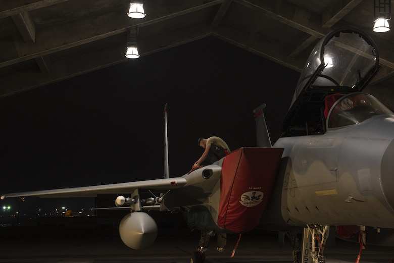 An 18th Aircraft Maintenance Squadron crew chief prepares a 67th Fighter Squadron F-15C Eagle for a mission at Kadena Air Base, Japan, Sept. 16, 2019.