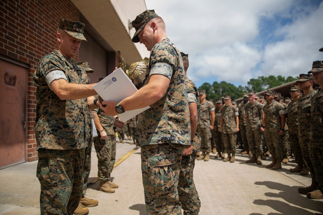 Major Gen. David Furness, commanding general 2nd Marine Division, left, presents the Navy Marine Corps Association Leadership Award to 1st Lt. Dillon Layman, executive officer Company C, 2nd Tank Battalion on Camp Lejeune, N.C., Aug. 27, 2019. The award was presented for outstanding performance in leadership billets. (U.S. Marine Corps photo by Cpl. Timothy J. Lutz)