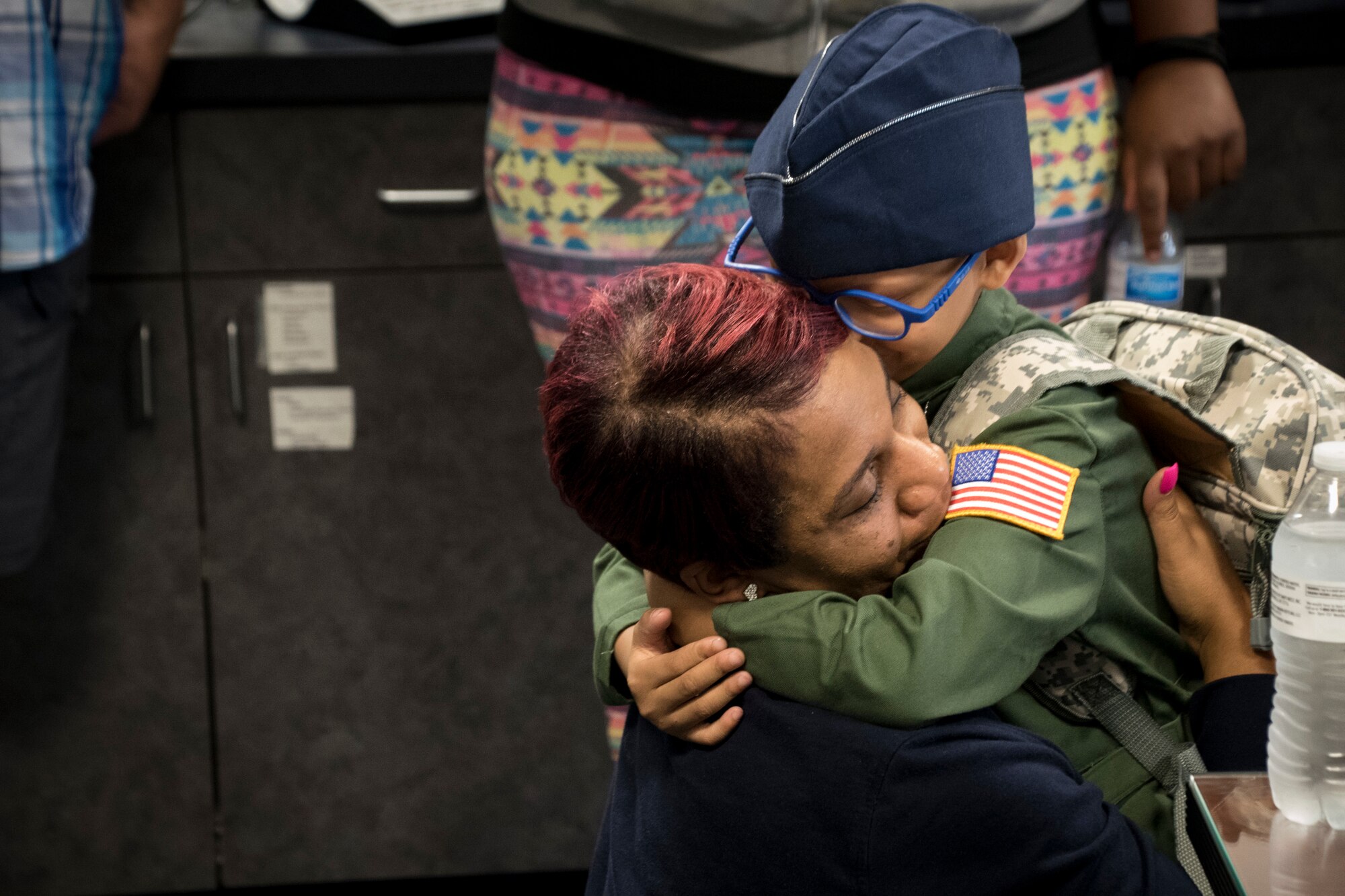 Ayden Houston hugs his mother after being named an honorary "Pilot for a Day" as part of a special event, Sept. 15, 2019, at the 179th Airlift Wing, Mansfield, Ohio. The 164th Airlift Squadron, assigned to the 179 AW, collaborated with “A Special Wish Foundation” of Cleveland, Ohio, to provide Ayden with this unique experience he could share with his family who have been battling a variety of health issues with Ayden since birth.  (U.S. Air National Guard photo by Tech. Sgt. Joe Harwood)