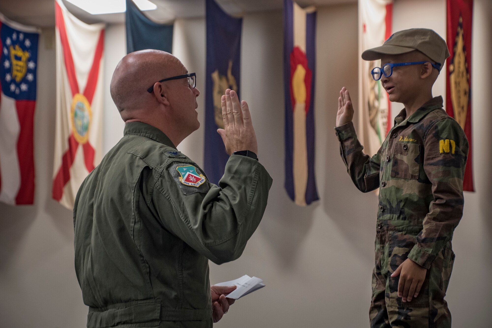 Col. Todd Thomas, 179th Airlift Wing commander, names Ayden Houston an honorary "Pilot for a Day" as part of a special event, Sept. 15, 2019, at the 179th Airlift Wing, Mansfield, Ohio. The 164th Airlift Squadron, assigned to the 179 AW, collaborated with “A Special Wish Foundation” of Cleveland, Ohio, to provide Ayden with this unique experience he could share with his family who have been battling a variety of health issues with Ayden since birth. (U.S. Air National Guard photo by Tech. Sgt. Joe Harwood)