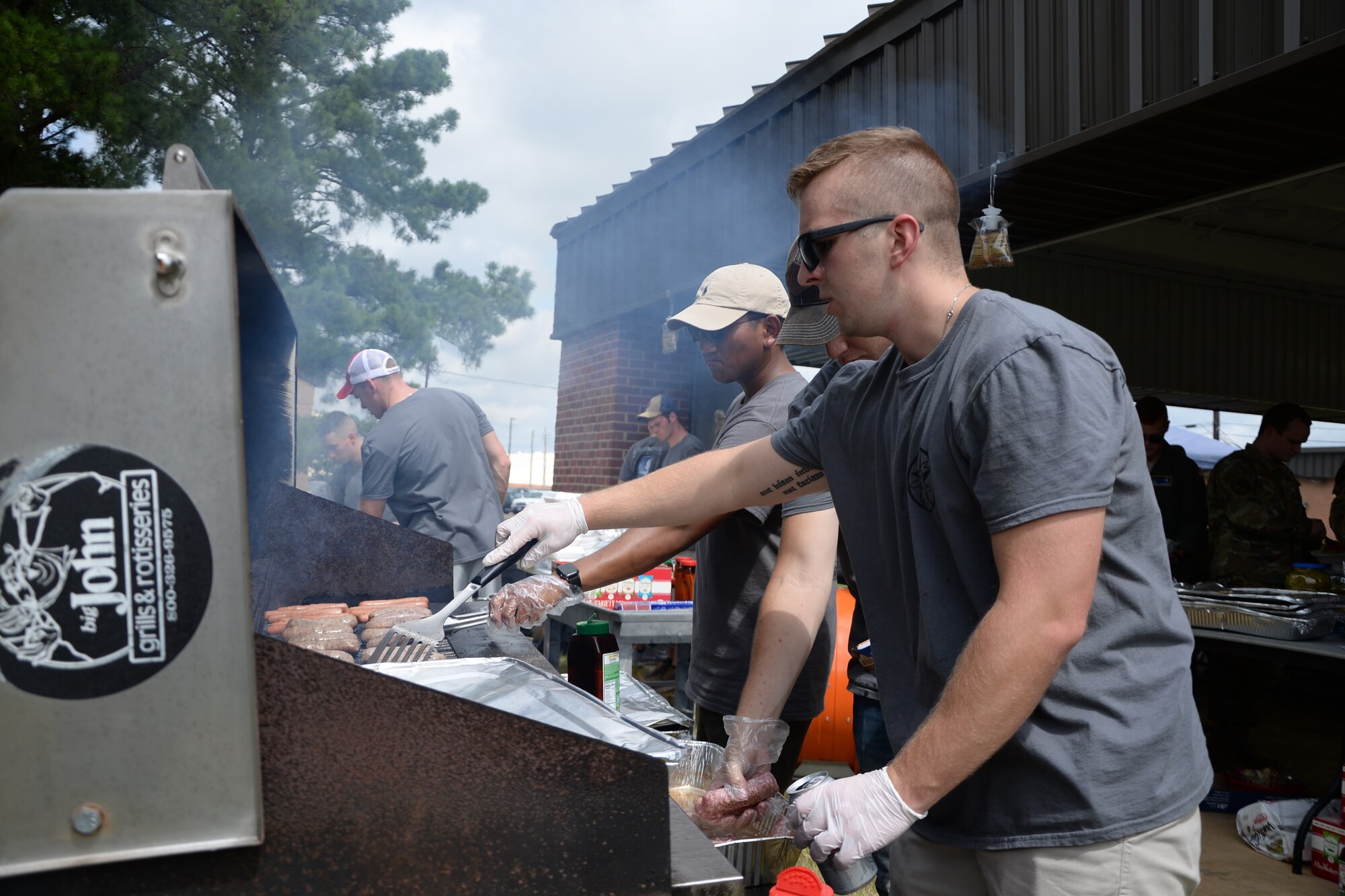 Members of the 14th Student Squadron grill burgers and brats during a barbeque Aug. 22, 2019, on Columbus Air Force Base, Mississippi. The barbeque was part of a Tactical Pause geared toward building resiliency amongst Airmen. (U.S. Air Force photo by Senior Airman Beaux Hebert)
