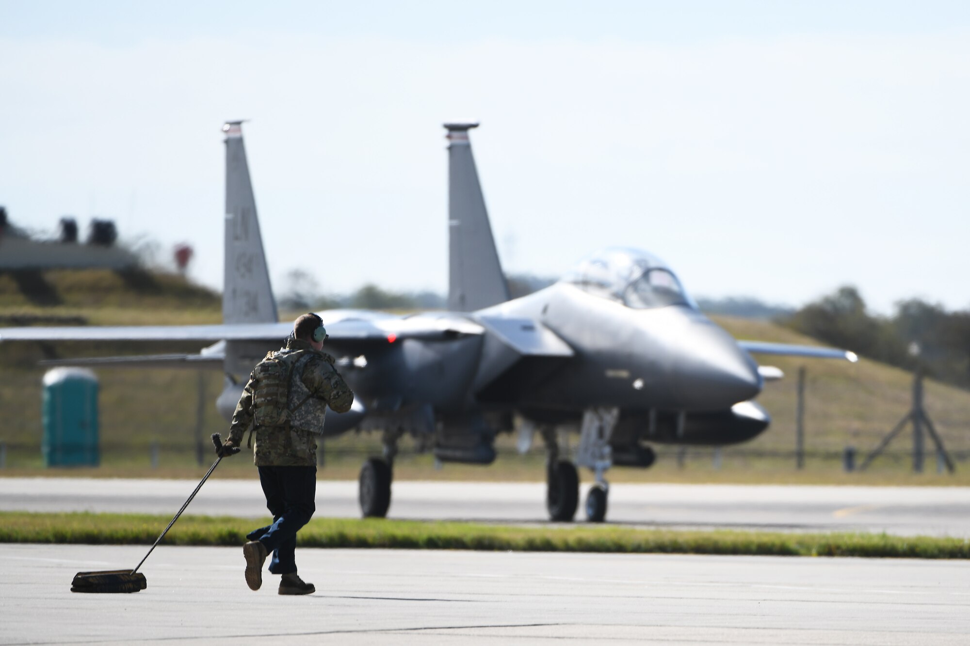 A crew chief assigned to the 48th Fighter Wing approaches an F-15E Strike Eagle assigned to the 494th Fighter Squadron on the flightline at Royal Air Force Mildenhall, England, Sept. 12, 2019. Airmen from the 48th FW participated in a Forward Arming and Refueling Point exercise alongside the 352nd Special Operations Wing and 100th Air Refueling Wing to build upon the relationships and integration between missions among different forces. (U.S. Air Force photo by Airman 1st Class Shanice Williams-Jones)