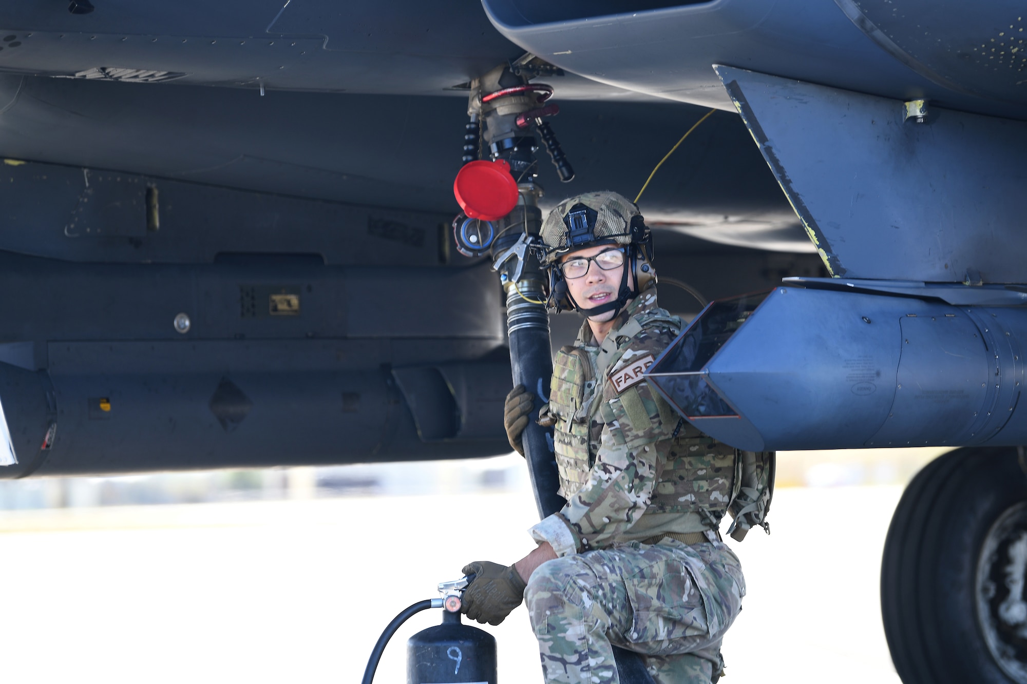 An Airman assigned to the 100th Air Refueling Wing refuels an F-15E Strike Eagle assigned to the 494th Fighter Squadron on the flightline at Royal Air Force Mildenhall, England, Sept. 12, 2019. The Airman participated in a Forward Arming and Refueling Point exercise alongside the 352nd Special Operations Wing and 48th Fighter Wing Airmen to build upon the relationships and integration between missions among different forces. (U.S. Air Force photo by Airman 1st Class Shanice Williams-Jones)