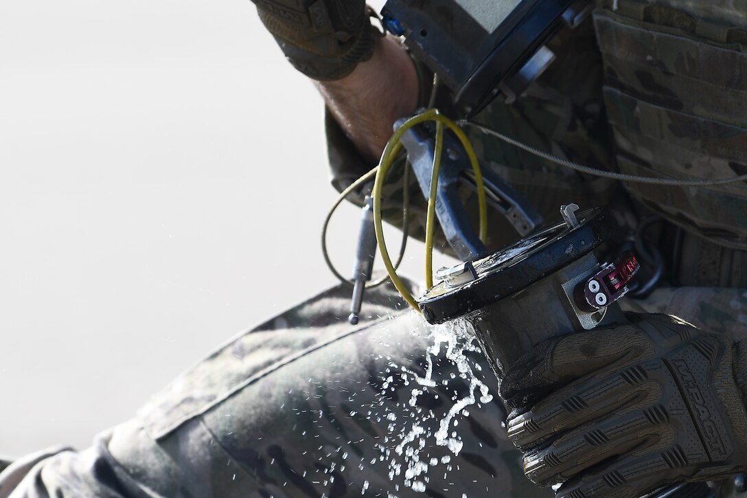 An Airman assigned to the 100th Air Refueling Wing secures a fuel line on the flightline at Royal Air Force Mildenhall, England, Sept. 12, 2019. The Airmen participated in a Forward Arming and Refueling Point exercise alongside the 352nd Special Operations Wing and 48th Fighter Wing Airmen to build upon the relationships and integration between missions among different forces. (U.S. Air Force photo by Airman 1st Class Shanice Williams-Jones)