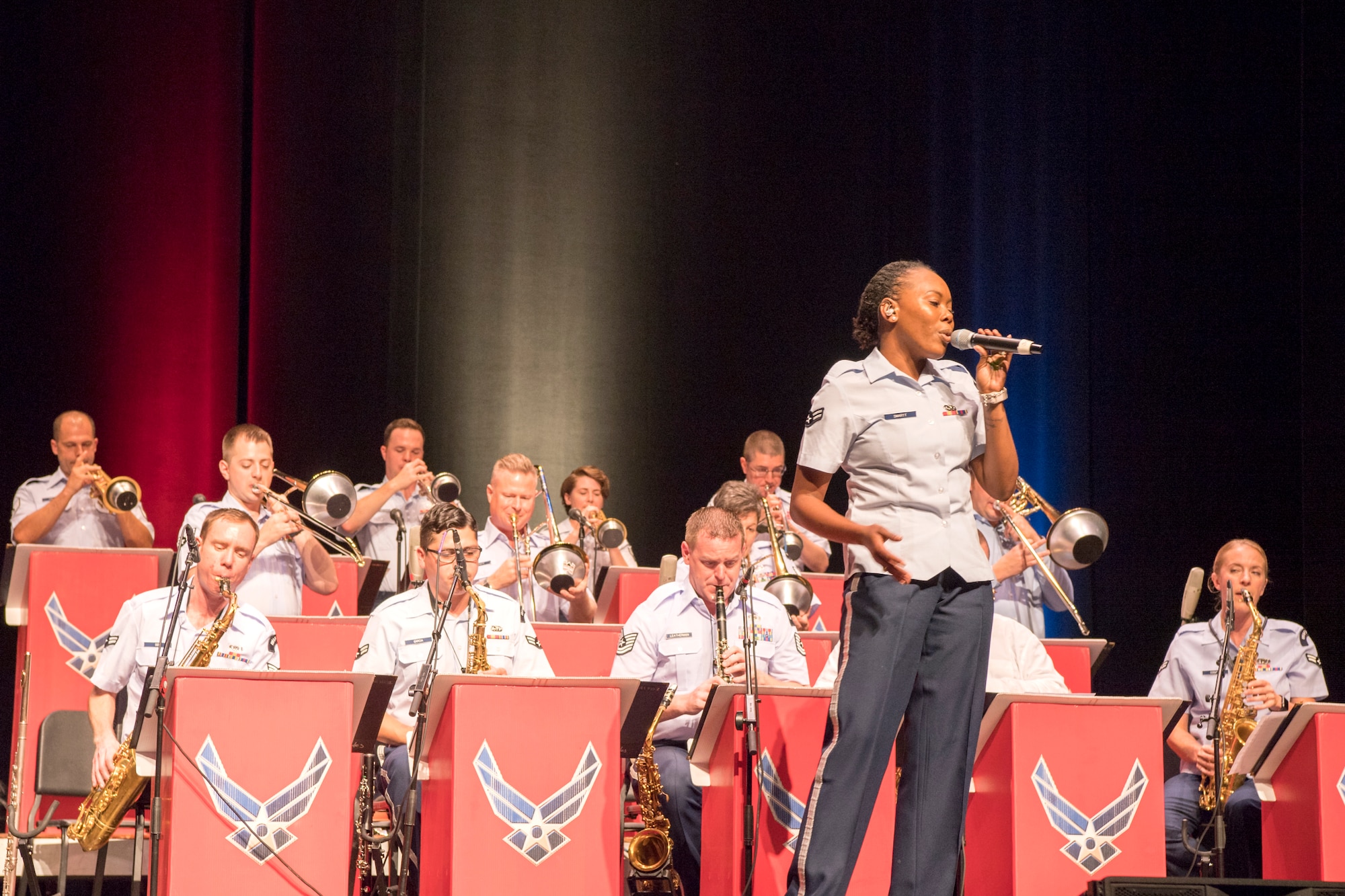 Airman 1st Class, Smartt, U.S. Air Force Band of Flight vocalist, sings during a concert at the Honeywell Center in Wabash, Indiana Sept. 10, 2019. The Band of Flight partnered with the Band of Mid-America to bring back the ‘big band jazz feel’. (U.S. Air Force photo/Master Sgt. Ben Mota)