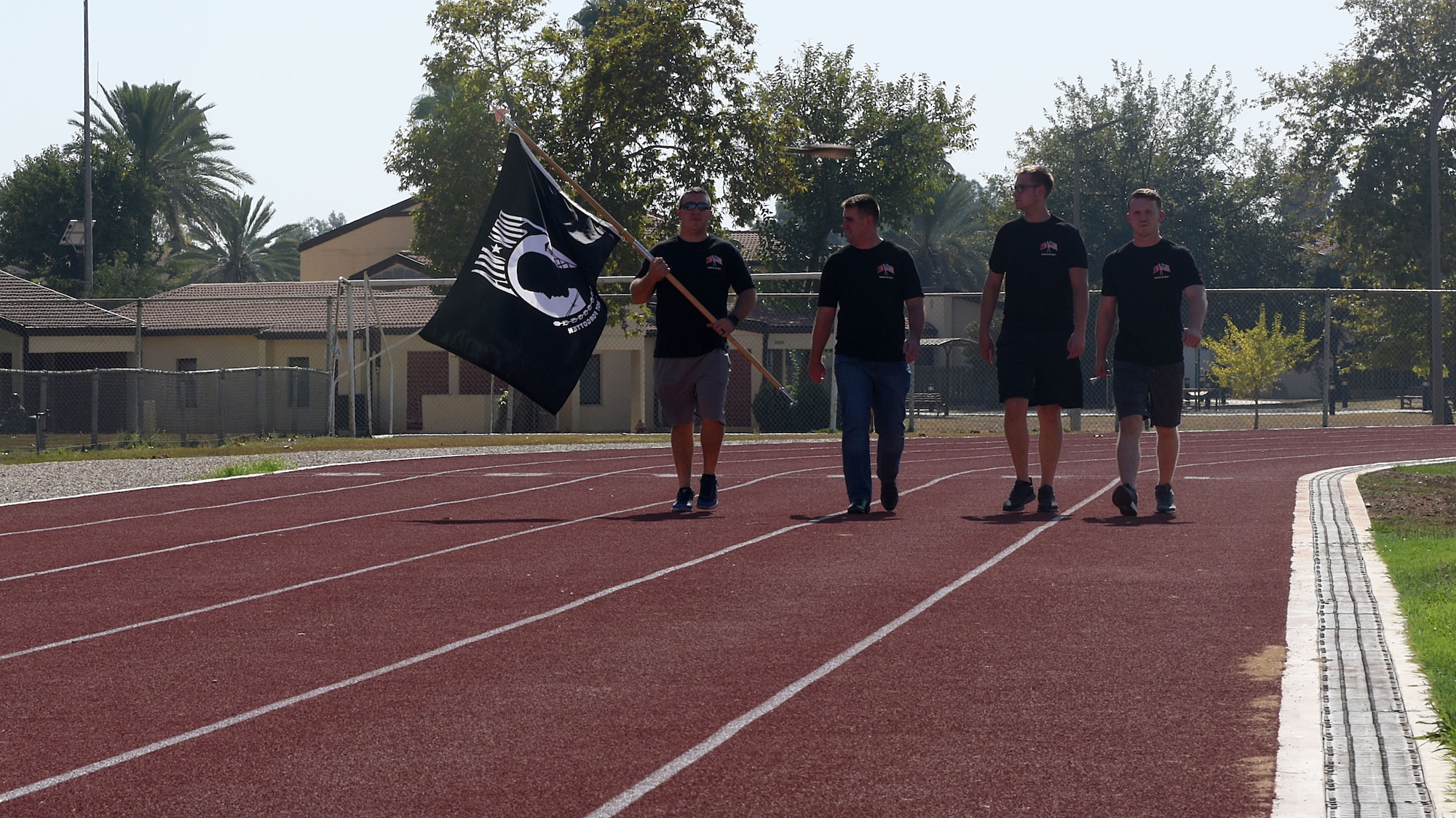 Members of the 728th Air Mobility Squadron carry the Prisoner of War/Missing in Action flag Sept. 19, 2019, at Incirlik Air Base, Turkey. These Airmen were the first to carry the flag during the event to honor POW/MIA service members. (U.S. Air Force photo by Staff Sgt. Trevor Rhynes)