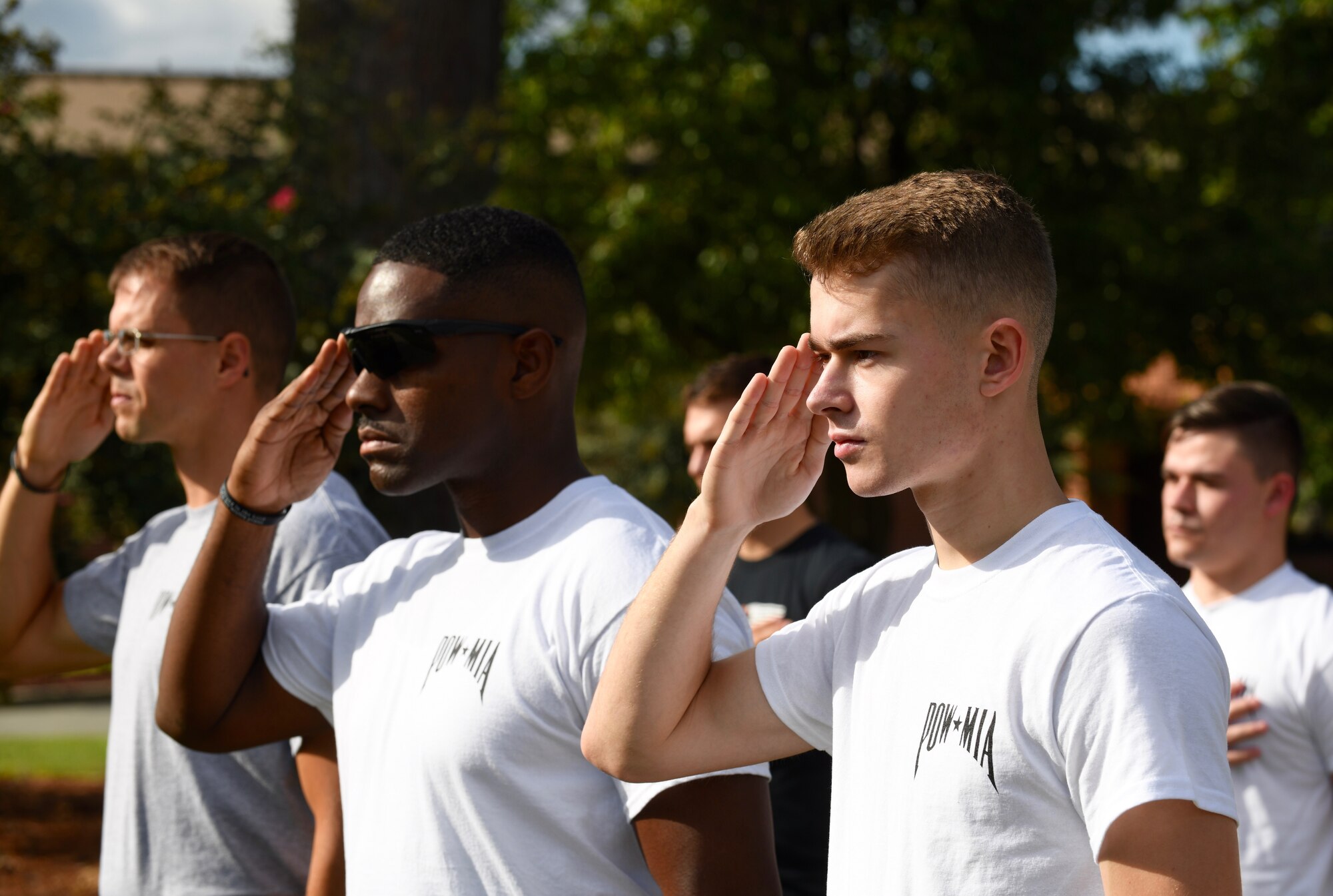Members of the 4th Fighter Wing salute during the POW/MIA Ceremony on Sept. 18, 2019, at Seymour Johnson Air Force Base, North Carolina. The ceremony, held in conjunction with national POW/MIA Recognition Day, also featured a missing-man formation flyover by four F-15E Strike Eagles assigned to the 4th FW, a reading of the Code of Conduct, a special presentation of the colors by the base honor guard and remarks by Goldsboro City Councilman Bill Broadway. (U.S. Air Force photo by Staff Sgt Michael Charles)