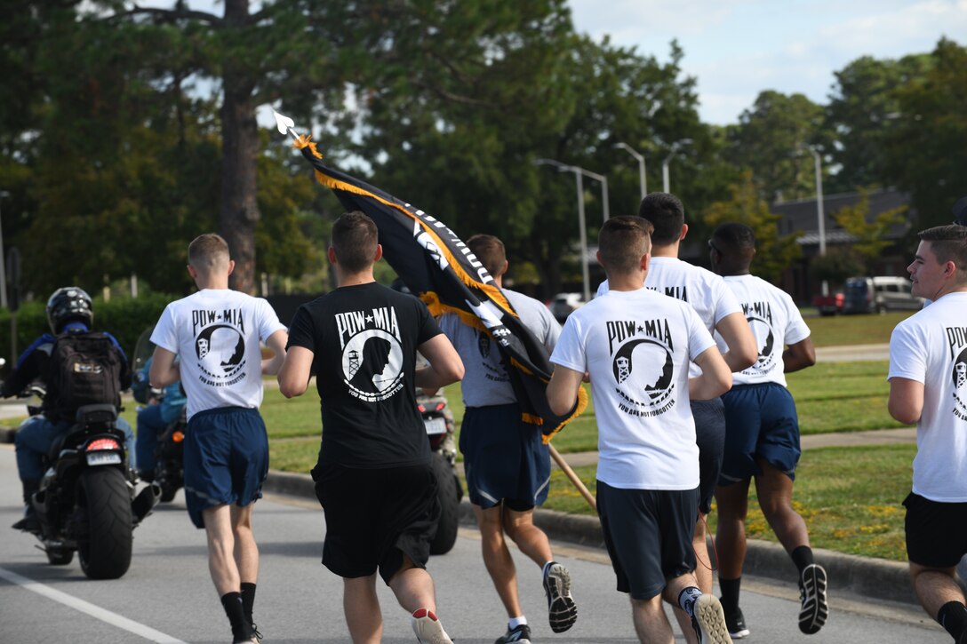 Members of the 4th Fighter Wing carry the POW/MIA flag for a 24 hour marathon Sept. 18, 2019, at Seymour Johnson Air Force Base, North Carolina. The event was held in conjunction with national POW/MIA Recognition Day. (U.S. Air Force photo by Staff Sgt Michael Charles)