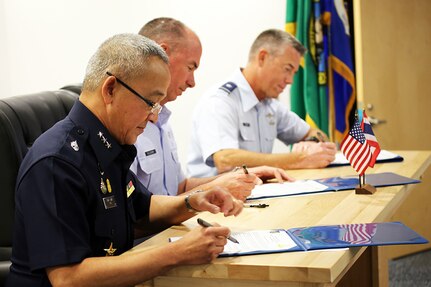 From left to right: Air Marshal Tarin Punsri, Royal Thai Air Force; Maj. Gen. Brian Killough, U.S. Air Force-Pacific Deputy Commander; and Brig. Gen. Jeremy Horn, assistant adjutant general, Washington Air National Guard, sign an agreement between units after the sixth Airmen-to-Airmen talks Aug. 28, 2019, at Camp Murray, Wash.