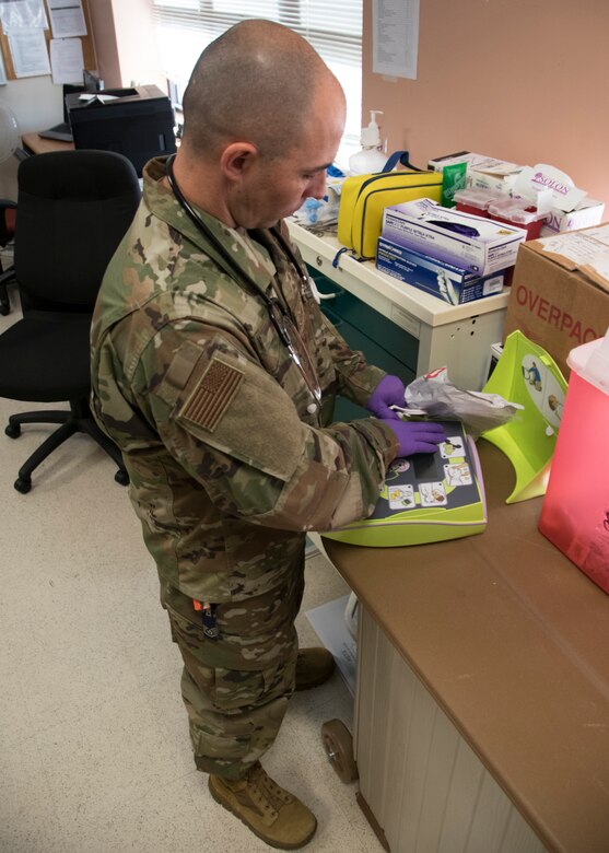 Tech Sgt. Simon Oliver, 459th Aeromedical Staging Squadron medical technician, looks at medical equipment during training, Sept. 19, 2019, at Joint Base Andrews, Md. Oliver recently played a part in saving a passengers life while on a commercial flight to Jamaica. (U.S. Air Force photo by Staff Sgt. Cierra Presentado/Released)