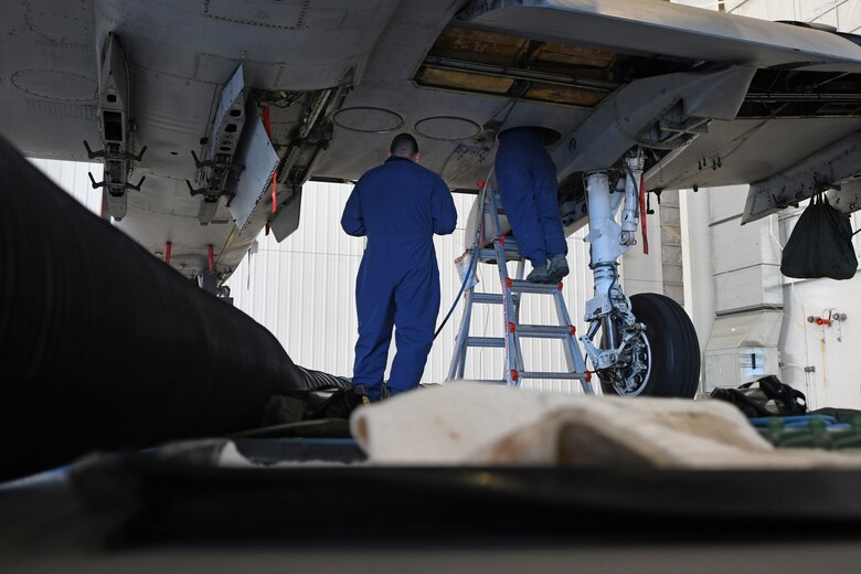 U.S. Air Force Airman 1st Class Grace Mathews, 355th Component Maintenance Squadron fuel system journeyman, enters the inside of an A-10 Thunderbolt II fuel tank while her attendant watches over her at Davis-Monthan Air Base, Arizona, Sept. 17, 2019.