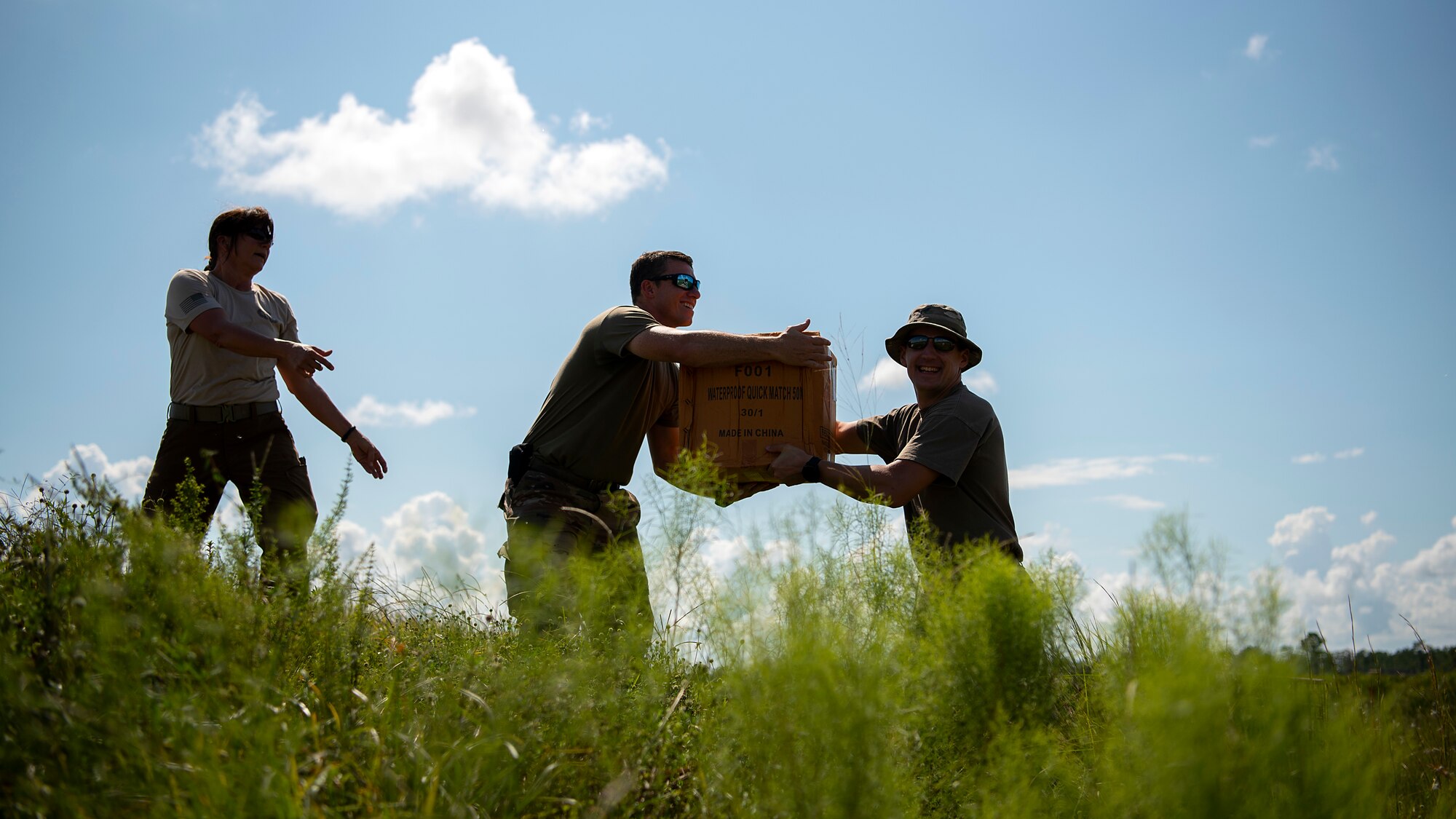 U.S. Air Force Staff Sgt. Benjamin McGovern (right), NCO in charge of explosive ordnance disposal operations assigned to the 6rh Civil Engineer Squadron, hands a box of explosives to U.S. Air Force Tech. Sgt. Michael Sweeney, NCO in charge of EOD quality assurance assigned to the 6th CES, during a joint disposal procedure at the Avon Park Air Force Range, Fla., Sept. 9, 2019. Federal, state and local authorities partnered to dispose of over 7,000 pounds of evidence following the conclusion of a federal case.