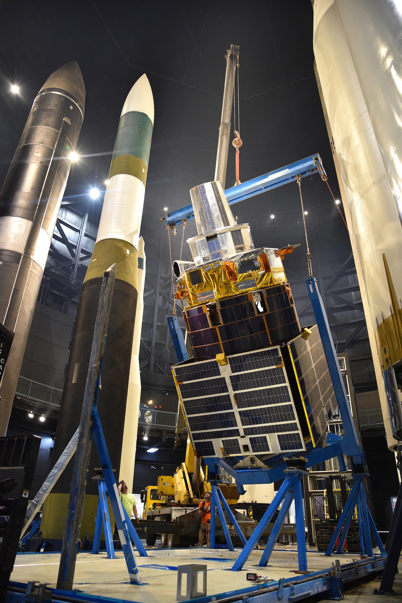 Photo of construction equipment and a test satellite.