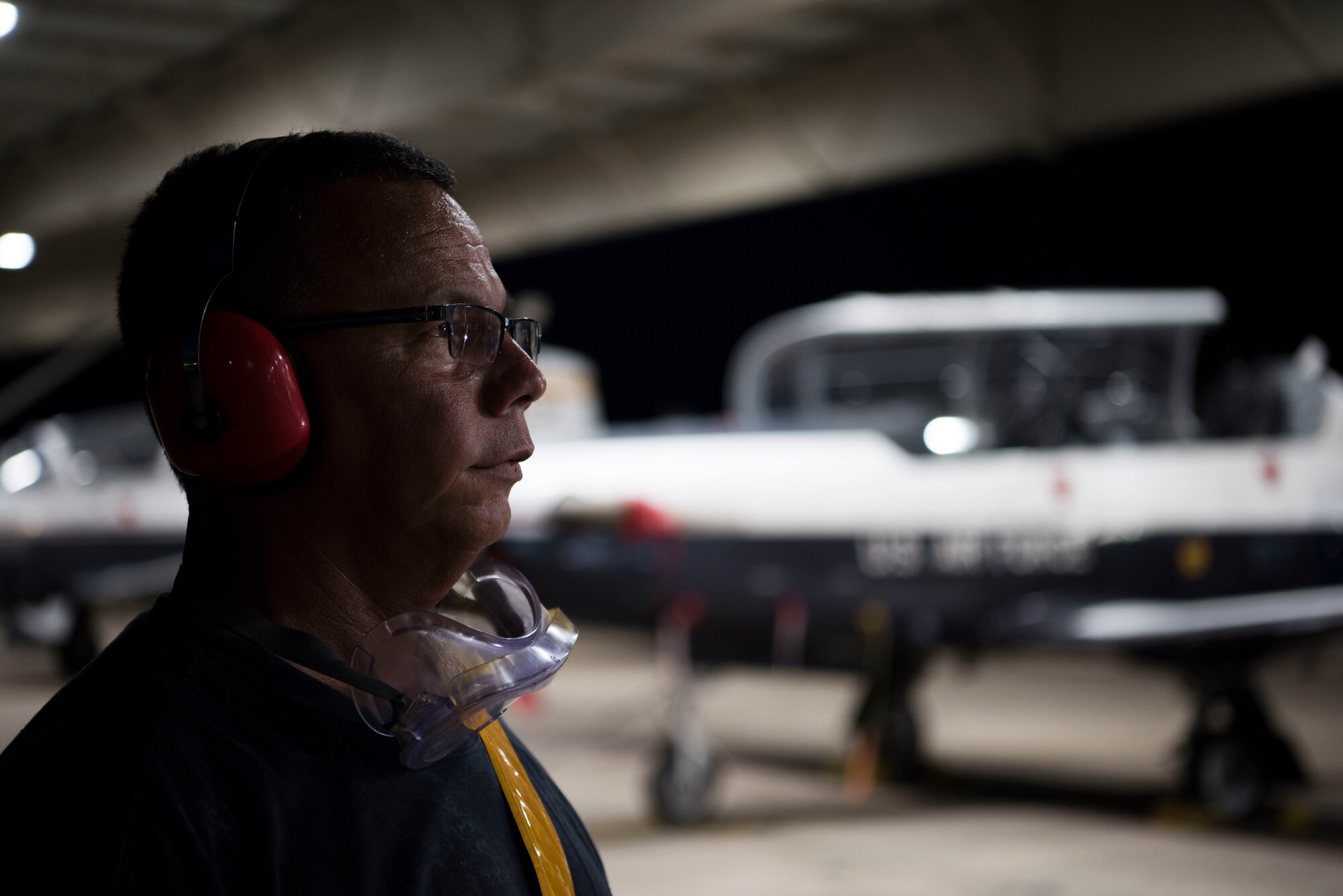 Art Ramirez, 47th Maintenance Directorate aircraft attendant gives a T-6A Texan II crew signals to prepare for takeoff, Sept. 18, 2019, at Laughlin Air Force Base, Texas. Night flying at a Specialized Undergraduate Pilot Training base allows not only more hours in the sky, but it also provides a variety experience so pilots can become accustomed to instrument flying. (U.S. Air Force photo by Senior Airman Marco A. Gomez)