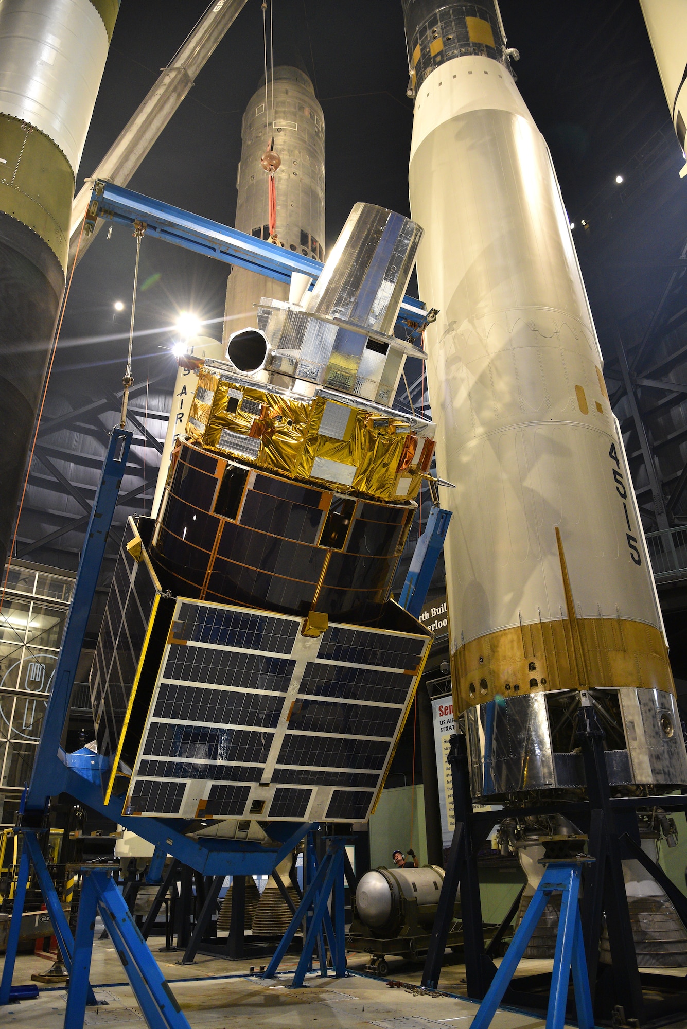 Photo of construction equipment and a test satellite.