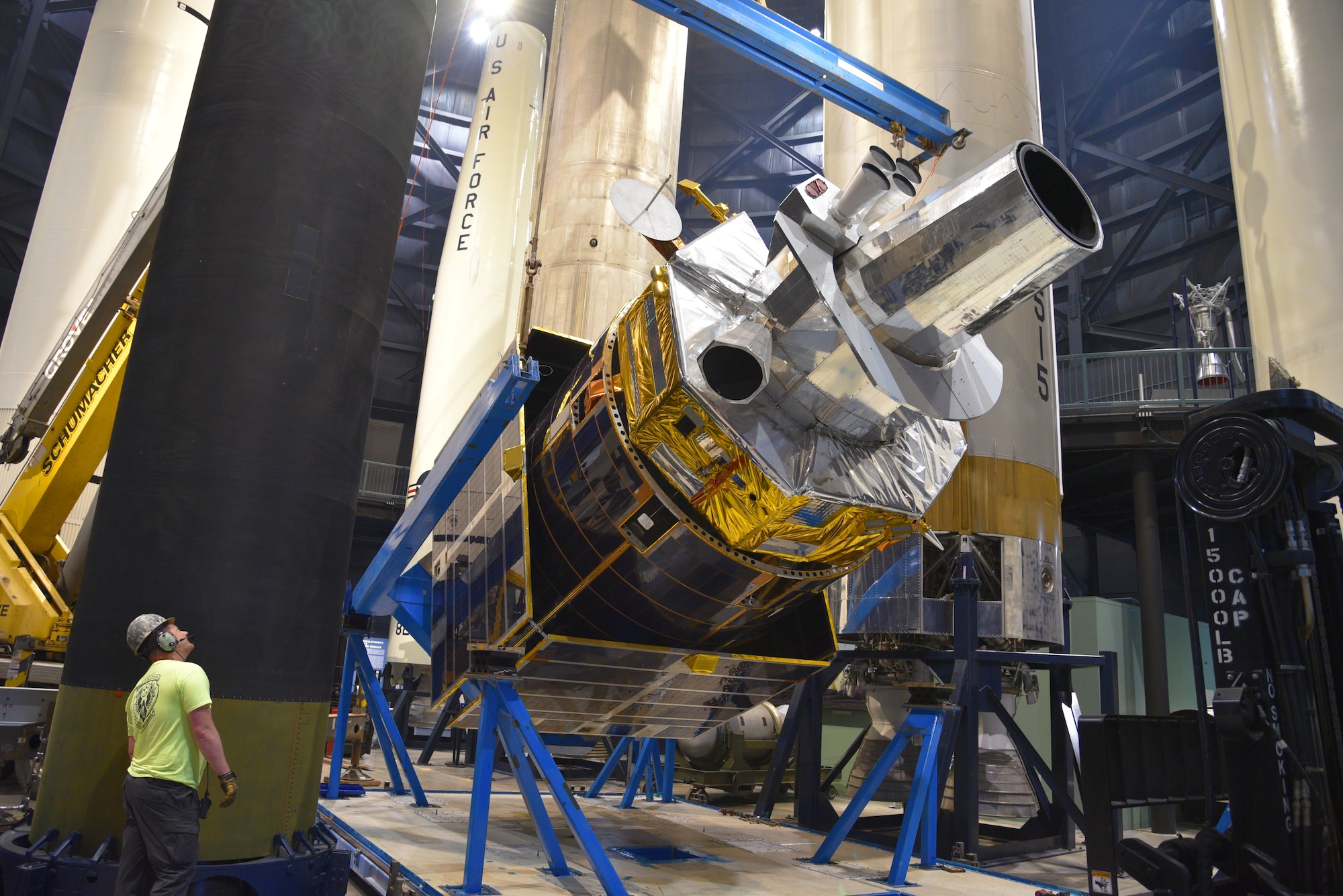 Photo of construction equipment and a test satellite.