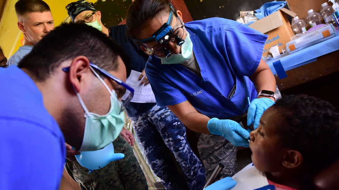 Members of the Pacific Angel 19-4 dental team tend to young patient at a health services outreach site in Lae, Papua New Guinea Sept. 9, 2019. Pacific Angel is multinational humanitarian assistance civil military engagement, improving military-to-military partnerships in the Pacific through medical health outreach, civic engineering projects and subject matter expert exchanges between U.S. service members, multinational militaries, non-governmental organizations, and PNG military and civilian participants. (U.S. Air Force photo by Tech. Sgt. Jerilyn Quintanilla)