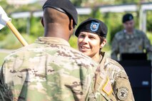 Capt. Ryan Sanders, left, outgoing commander, Houston Medical Recruiting Company, passes the guidon to Lt. Col. Mary Rivera, commander, 5th Medical Recruiting Battalion during the Houston MRC change of command ceremony at Hermann Park Conservancy, Houston, Texas, Sept. 5.