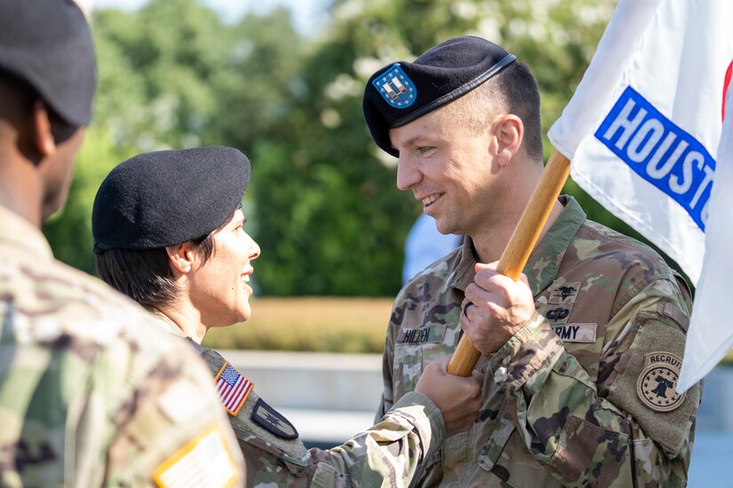 Lt. Col. Mary Rivera, left, commander, 5th Medical Recruiting Battalion, passes the company guidon to Capt. David Hilden, incoming commander, Houston Medical Recruiting Company, during the Houston MRC change of command ceremony at Hermann Park Conservancy, Houston, Texas, Sept. 5.