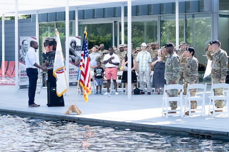 Soldiers and family members assigned to the Houston Medical Recruiting Company render honor during the singing of the National Anthem by Otis Toussaint, 5th Medical Recruiting Battalion, at the unit's change of command ceremony at Hermann Park Conservancy, Houston, Texas, Sept. 5.