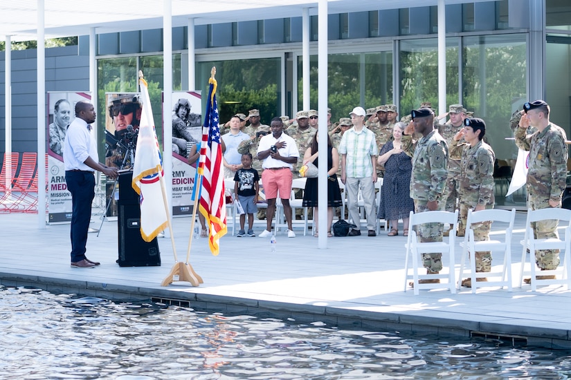 Soldiers and family members assigned to the Houston Medical Recruiting Company render honor during the singing of the National Anthem by Otis Toussaint, 5th Medical Recruiting Battalion, at the unit's change of command ceremony at Hermann Park Conservancy, Houston, Texas, Sept. 5.