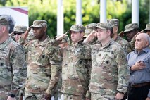 Soldiers and family members assigned to the Houston Medical Recruiting Company render honor during the National Anthem at the unit's change of command ceremony at Hermann Park Conservancy, Houston, Texas, Sept. 5.