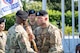 1st Sgt. Brian Filipowski, right, senior enlisted advisor, Houston Medical Recruiting Company, hands the company guidon to Capt. Ryan Sanders, left, outgoing commander, Houston MRC, during the company's change of command ceremony at Hermann Park Conservancy, Houston, Texas, Sept. 5.