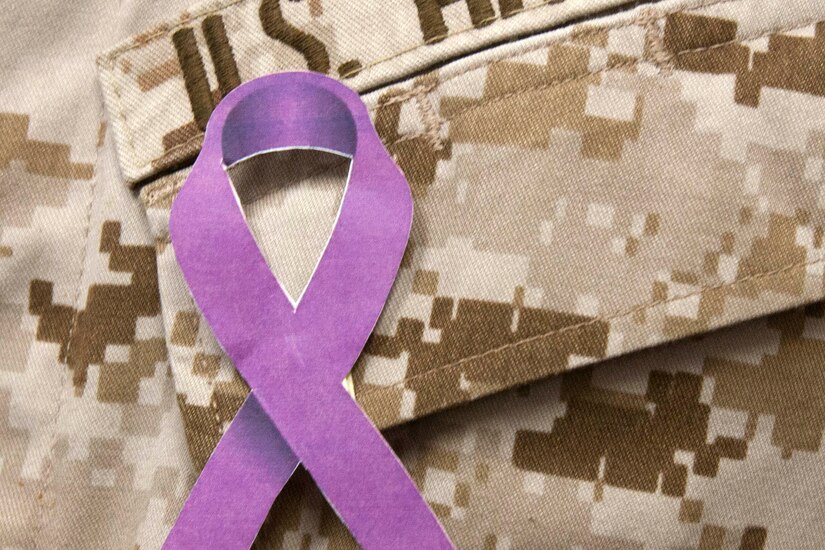 A purple ribbon on a military uniform.