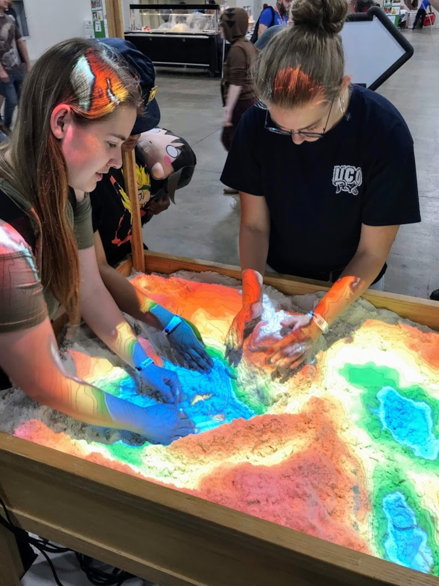 Participants at the 2019 FanX event play with a 3D interactive topographical map sandbox the Hill Air Force Base Science, Technology, Engineering and Math exhibit.  The event, which  was held at the Salt Palace Convention Center Sept. 5-7, drew thousands of visitors, providing great exposure for Hill and its STEM programs.