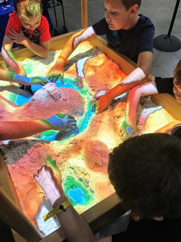 Participants at the 2019 FanX event play with a 3D interactive topographical map sandbox the Hill Air Force Base Science, Technology, Engineering and Math exhibit.  The event, which  was held at the Salt Palace Convention Center Sept. 5-7, drew thousands of visitors, providing great exposure for Hill and its STEM programs.