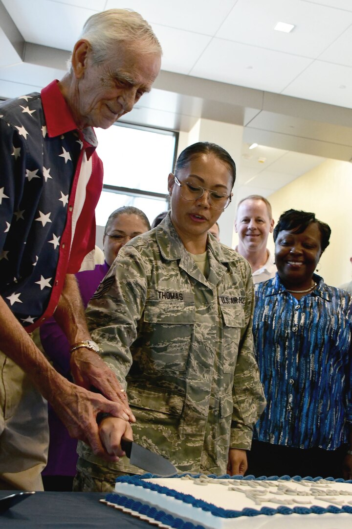 The oldest and youngest Marine cut the Air Force birthday cake.