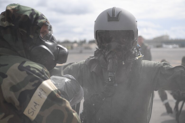 Aircrew Flight Equipment personnel decontaminate Lt. Col. Kevin Parsons, 93rd Air Refueling Squadron commander, Fairchild Air Force Base, Washington, is patted down for decontaminants after a simulated Ability to Survive and Operate scenario during Exercise Mobility Guardian at Yakima Air Terminal-McAllister Field, Washington, Sept. 16, 2019. Exercise Mobility Guardian is Air Mobility Command's premier, large scale mobility exercise. Through robust and relevant training, Mobility Guardian improves the readiness and capabilities of Mobility Airmen to deliver rapid global mobility and builds a more lethal and ready Air Force. (U.S. Air Force photo by Tech. Sgt. Luther Mitchell)