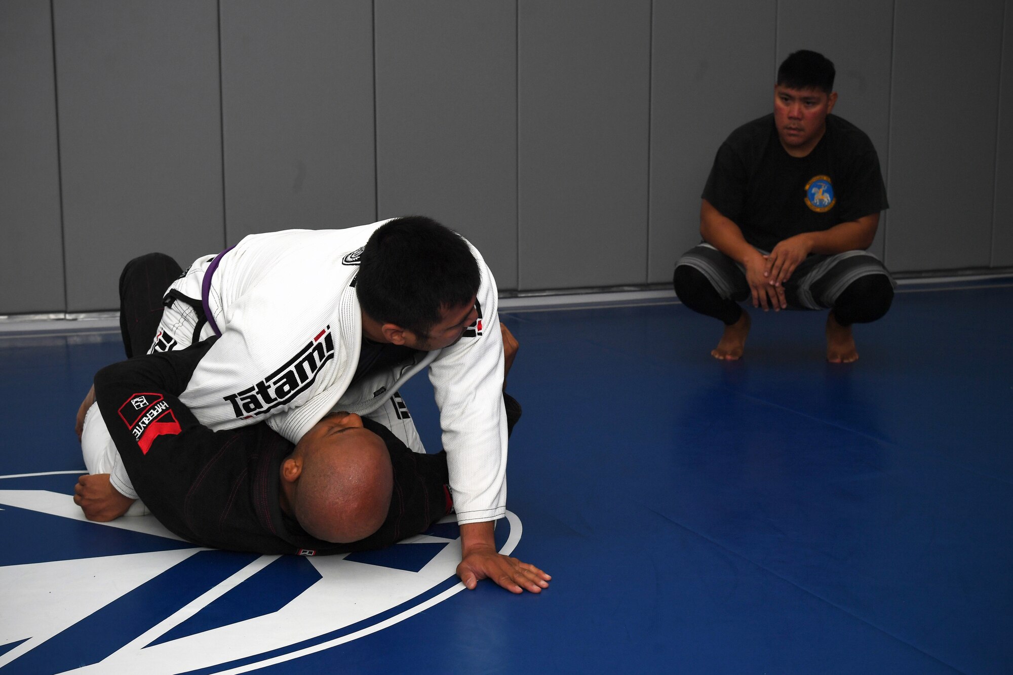 Tech. Sgt. Darwin Valencia, 319th Logistics Readiness Squadron travel management office section chief, top left, and Tech. Sgt. John Squire, 319th Healthcare Operational Squadron mental health flight chief, bottom left, demonstrate Jiu Jitsu grappling techniques during a resiliency event Sept. 18, 2019, on Grand Forks Air Force Base, North Dakota. The event, “Grappling with Adversity,” was attended by members on base to learn how coping with stress and hardship through physical activity such as Jiu Jitsu is a health option to maintain good mental health and resilience. (U.S. Air Force photo by Senior Airman Elora J. Martinez)