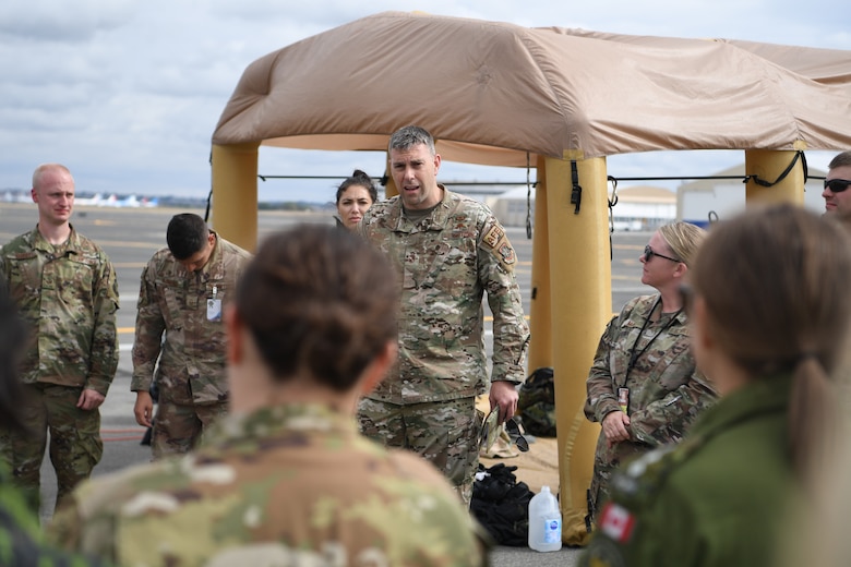 U.S. Air Force Senior Master Sgt. David Siemiet, Air Mobility Command aircrew flight equipment manager, outbriefs exercise participants during Exercise Mobility Guardian at Yakima Air Terminal-McAllister Field, Washington, Sept. 16, 2019. Exercise Mobility Guardian is Air Mobility Command's premier, large scale mobility exercise. Through robust and relevant training, Mobility Guardian improves the readiness and capabilities of Mobility Airmen to deliver rapid global mobility and builds a more lethal and ready Air Force. (U.S. Air Force photo by Tech. Sgt. Luther Mitchell)