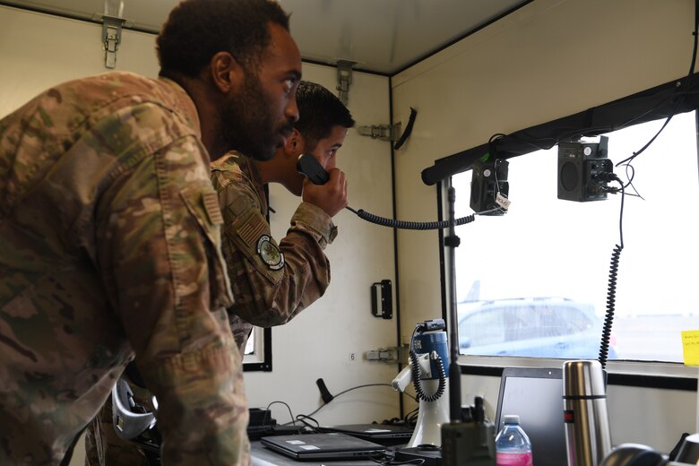Master Sgt. Jeremiah Ibarra, left, 321st Contingency Response Team chief, Travis Air Force Base, California responds to an simulated inflight emergency during Exercise Mobility Guardian at Moses Lake, located west of Fairchild Air Force Base, Washington. Mobility Guardian test joint and total force response to threats faced in the current fight and potential higher-end threats in future wars. (U.S. Air Force photo by Tech. Sgt. Luther Mitchell Jr.)