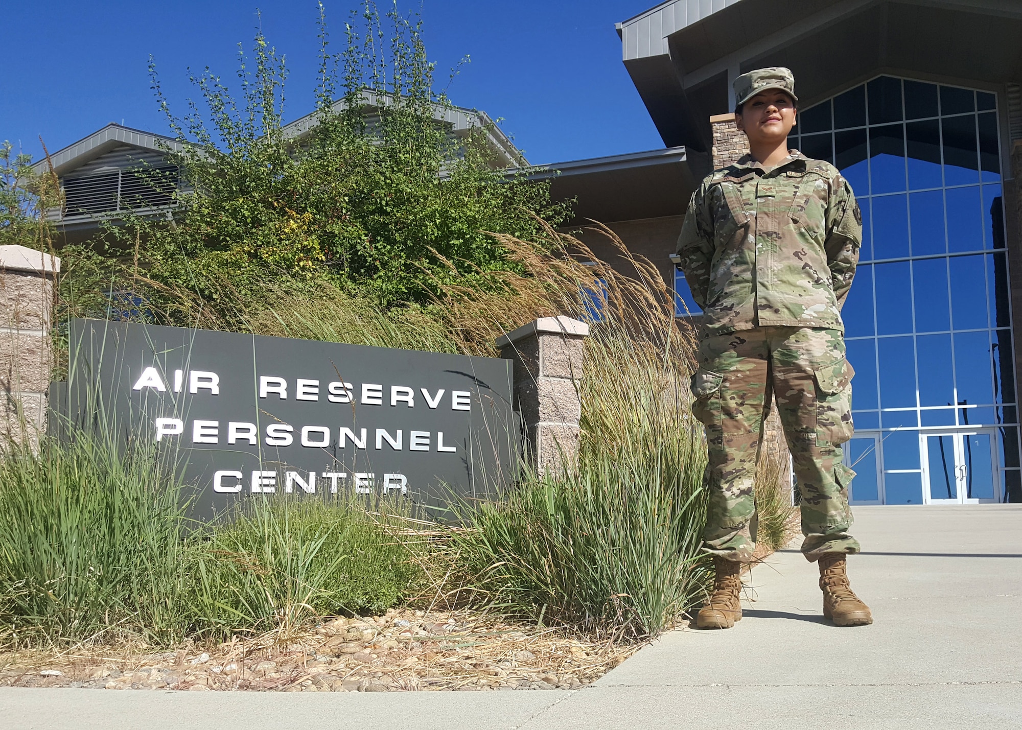 Senior Airman Upasana Nepal, a reserve separations technician at Headquarters Air Reserve Personnel Center, Buckley Air Force Base, Colorado, stands in front of the HQ ARPC building. Nepal, who has the same last name as her birth country, Nepal, immigrated to the United States in 2012 as a refugee. She joined the Air Force Reserve in 2017 and is now a citizen. (U.S. Air Force photo by Master Sgt. Leisa Grant/Released)