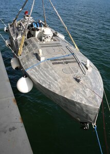A view of an unmanned surface vehicle (USV) being brought aboard Military Sealift Command's expeditionary sea base