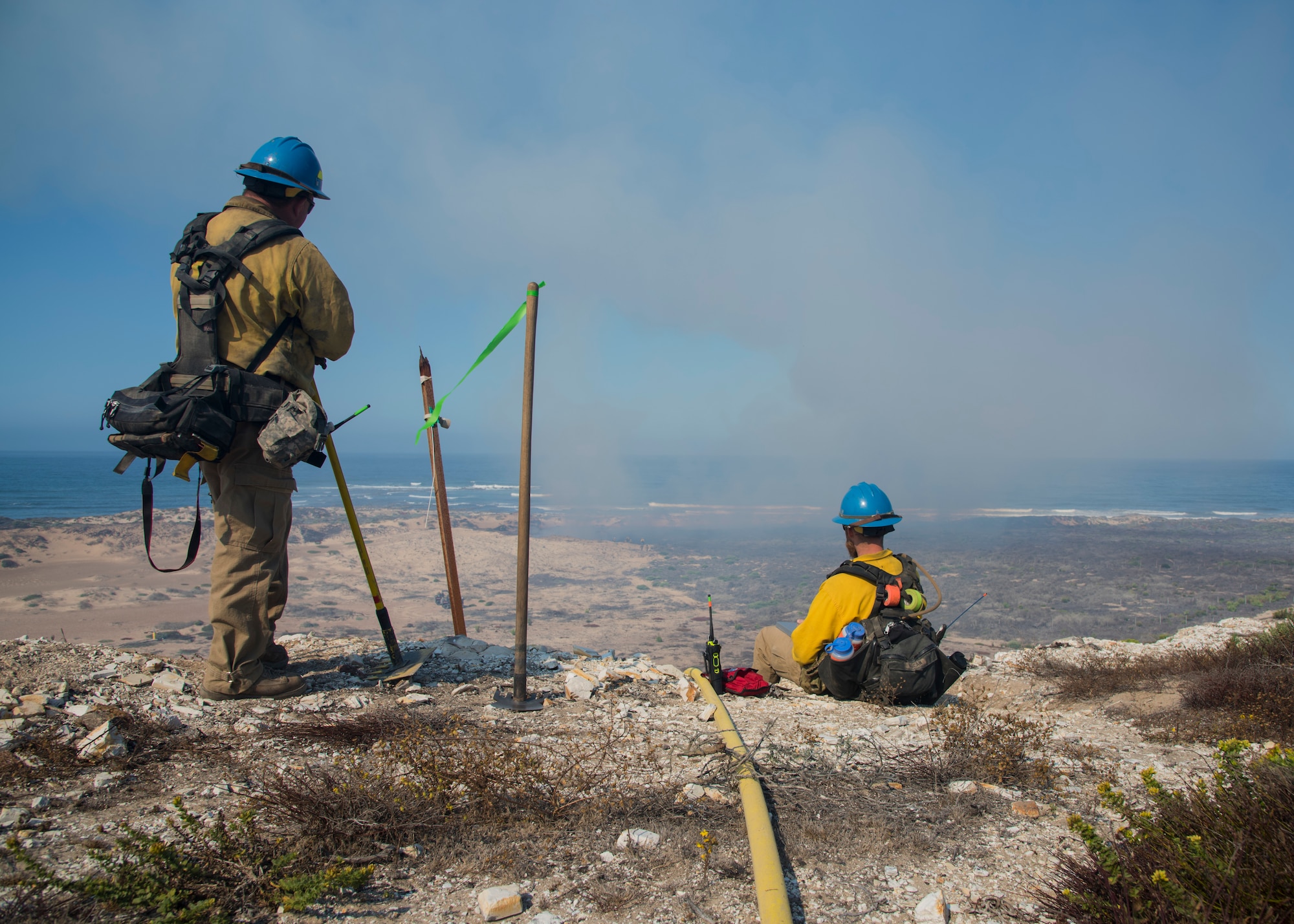 Mike Rivera and Alex Duncan, Vandenberg Wildland Support Module fire operation technicians, observe the controlled fire Sept. 18, 2019 at Vandenberg Air Force Base, Calif. The Vandenberg Fire Department and Hotshots team conducted a prescribed burn of grassland and coastal sage scrub. (U.S. Air Force photo by Airman 1st Class Aubree Milks)