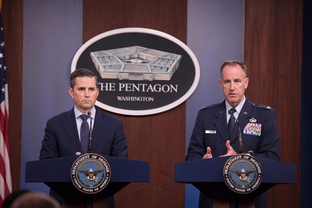 Two men address Pentagon reporters.