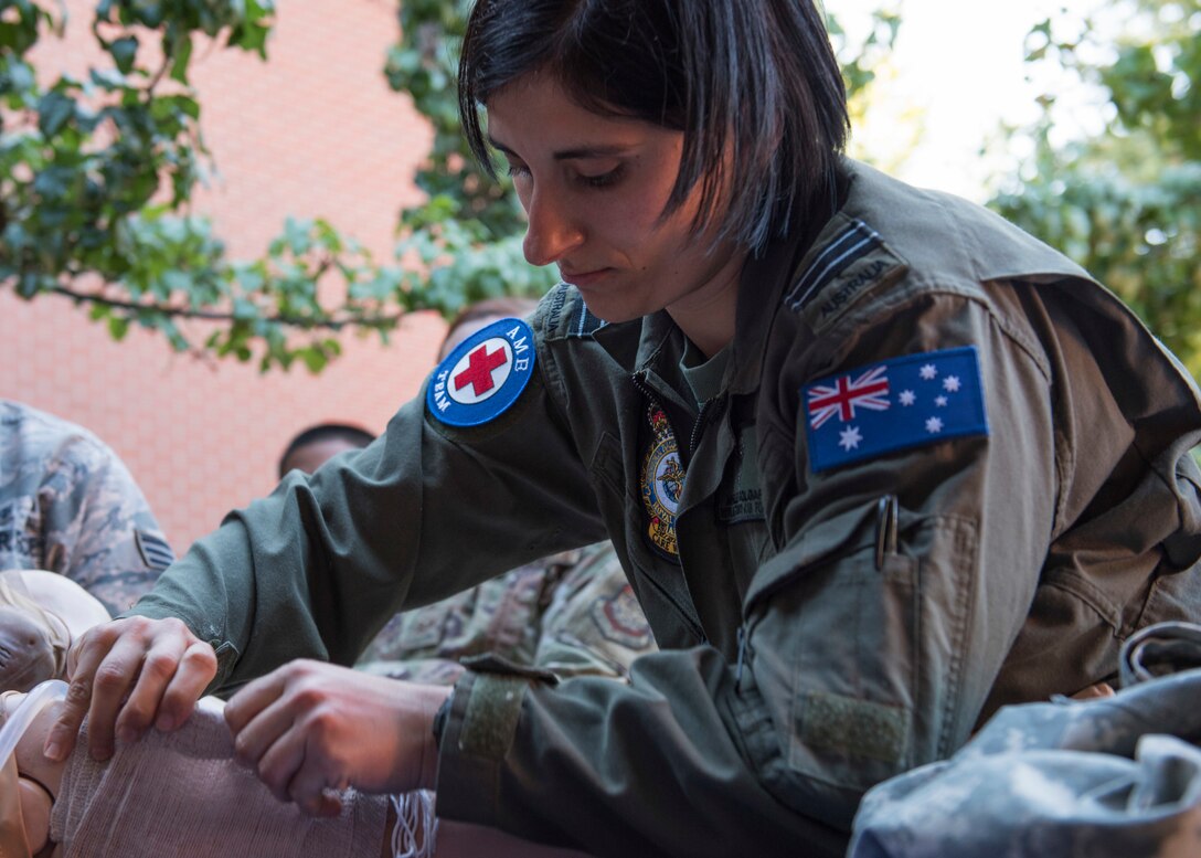 Royal Australian Air Force Flight Lt. Michelle Polgar, RAAF medic, applied a wound-dressing to a hemorrhage simulation training mannequin during the Tactical Combat Casualty Care course at Fairchild Air Force Base, Washington, Sept. 12, 2019. TCCC is designed to help lessen preventable combat deaths by providing proven trauma stabilization techniques, allowing for wounded to survive long enough to receive life-saving treatment. (U.S. Air Force photo by Senior Airman Ryan Lackey)