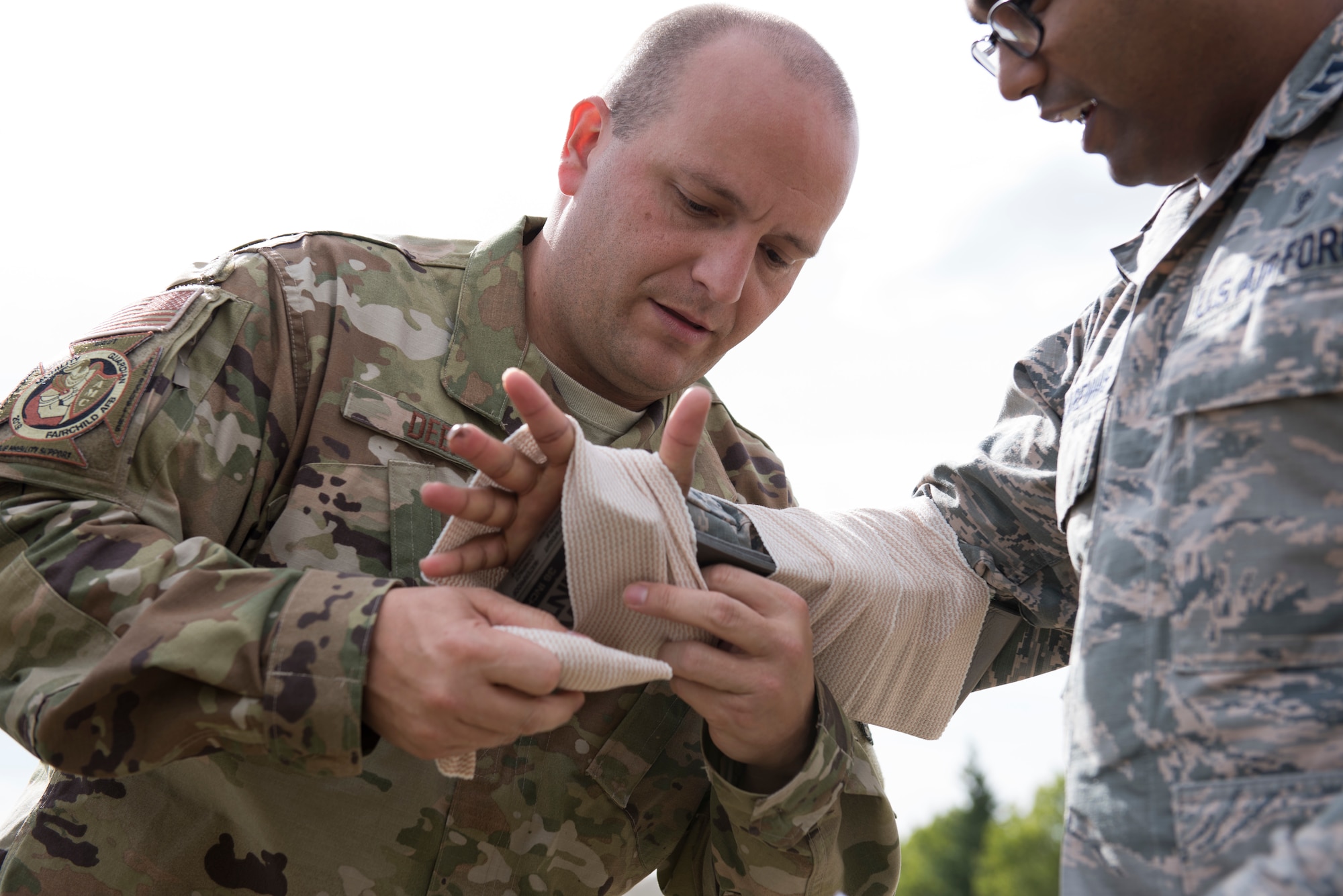 U.S. Air Force 1st Lt. Jeremy Deep, Air Mobility Command aeromedical operations officer, applies a splint to U.S. Air Force Capt. Amaro Mascarenhas, 375th Aeromedical Evacuation Squadron resource management officer, during the Tactical Combat Casualty Care course at Fairchild Air Force Base, Washington, Sept. 12, 2019. The TCCC is the replacement for the former Self-Aid Buddy Care first aid training and will become the new standard across all U.S. military service branches. (U.S. Air Force photo by Senior Airman Ryan Lackey)