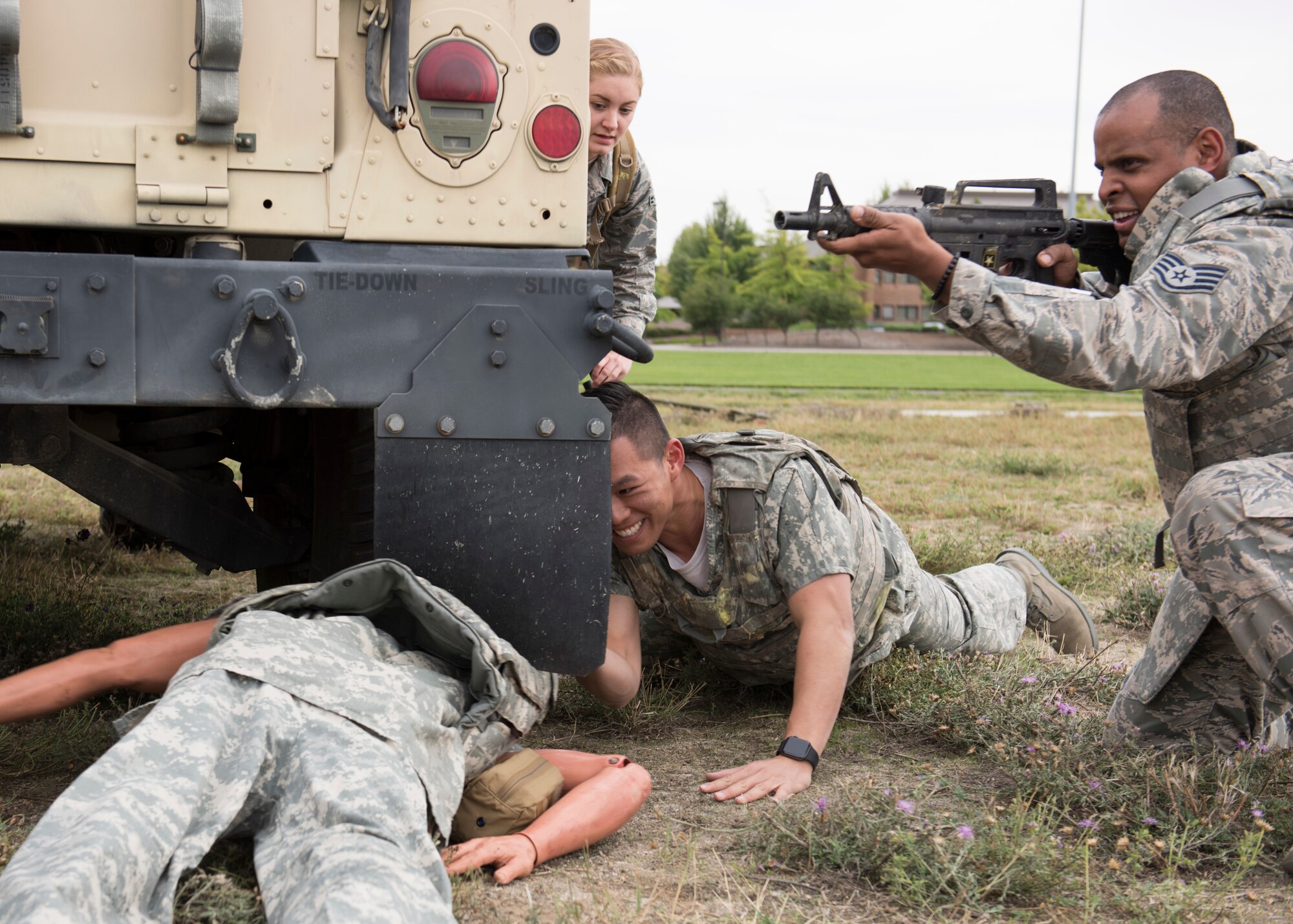 U.S. Air Force students provide cover while pulling a ‘wounded’ training mannequin out of simulated line-of-fire during the Tactical Combat Casualty Care course at Fairchild Air Force Base, Washington, Sept. 12, 2019. Battlefield simulation drills are vital to provide medics and combat personnel with realistic situations where they provide life-saving care and evacuation of wounded. (U.S. Air Force photo by Senior Airman Ryan Lackey)