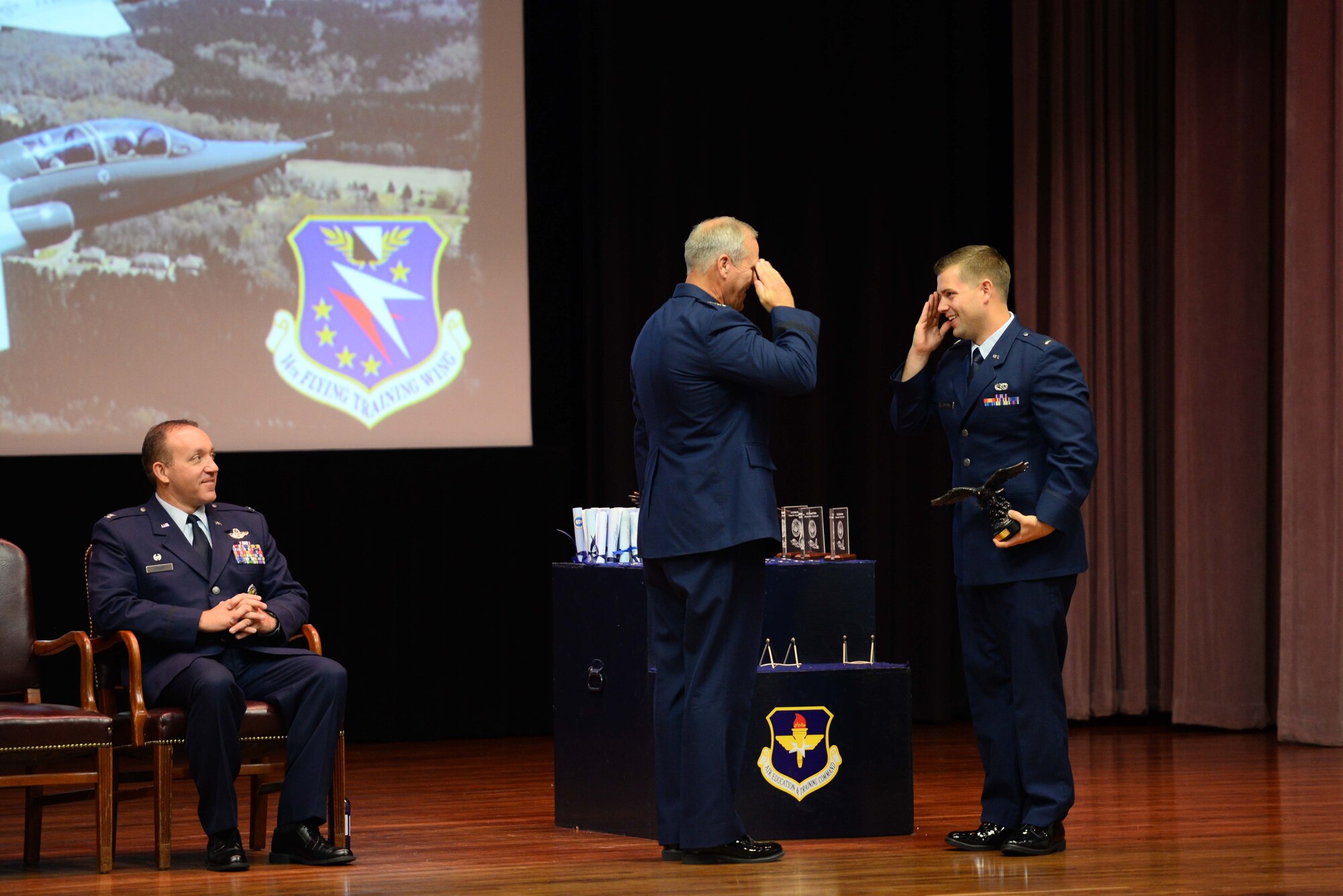 Retired Lt. Gen. Jeffrey Lofgren, former Deputy Chief of Staff for Capability Development, salutes 2nd Lt. Logan Adcock, Sept. 13, 2019, on Columbus Air Force Base, Mississippi. Lofgren presented three graduates the Air Education and Training Command Commander’s Trophy for being the most outstanding students overall in their classes. (U.S. Air Force photo by Airman 1st Class Jake Jacobsen)