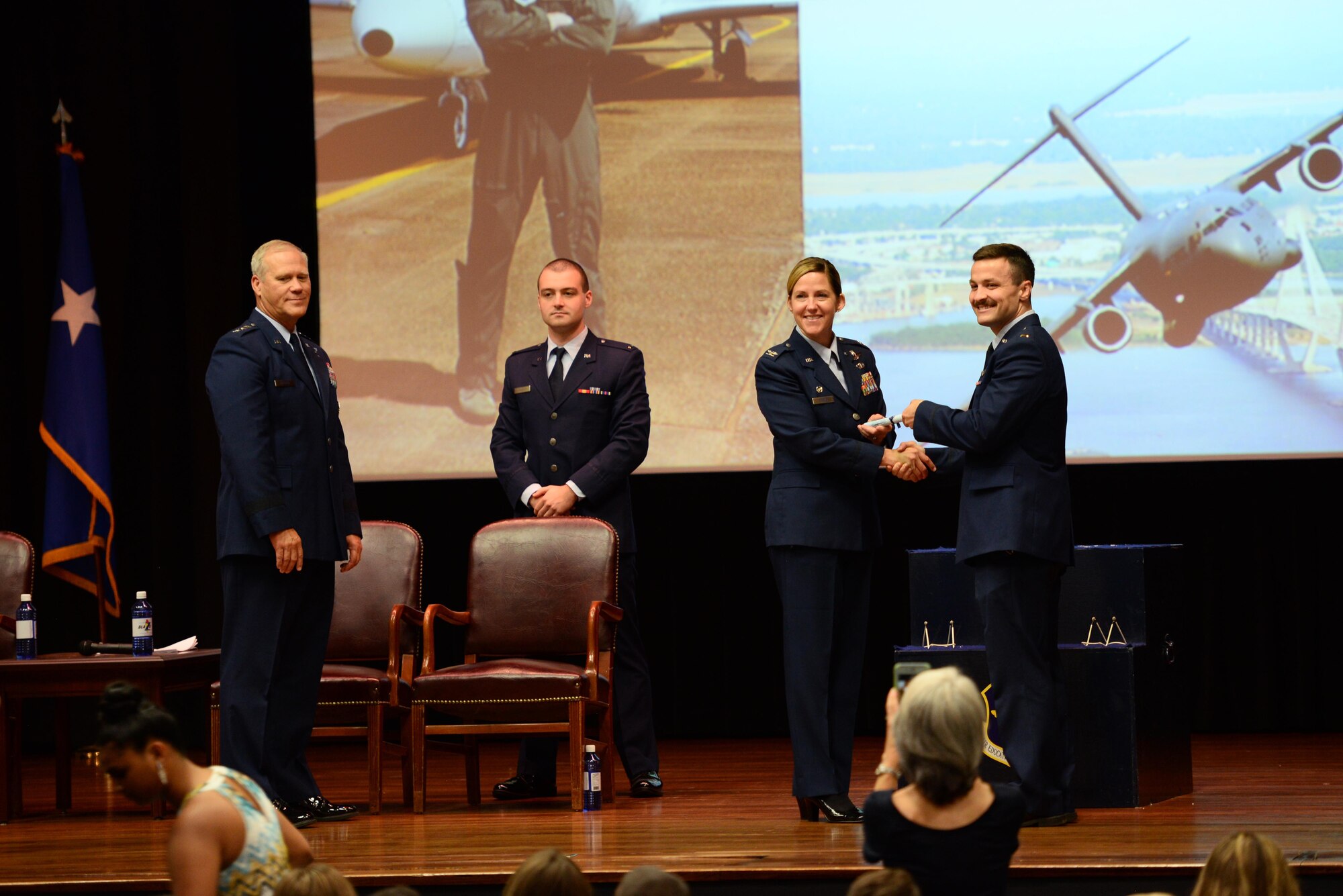 Col. Samantha Weeks, 14th Flying Training Wing commander, presents 2nd Lt. Julius Peek III his certificate of graduation, Sept. 13, 2019, on Columbus Air Force Base, Mississippi. After graduating pilot training at Columbus AFB, pilots will now go to their specified base to start training on their assigned aircraft. (U.S. Air Force photo by Airman 1st Class Jake Jacobsen)