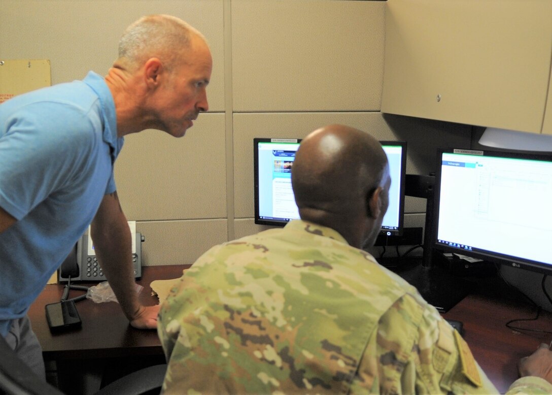 340th Flying Training Group Emergency Management Program Manager Shane MacDonald and group logistics plan superintendent Senior Master Sgt. Kwame Tawiah discuss plans for the unit’s recall exercise held Aug. 22 at Joint Base San Antonio-Randolph, Texas. (U.S. Air Force photo by Debbie Gildea)