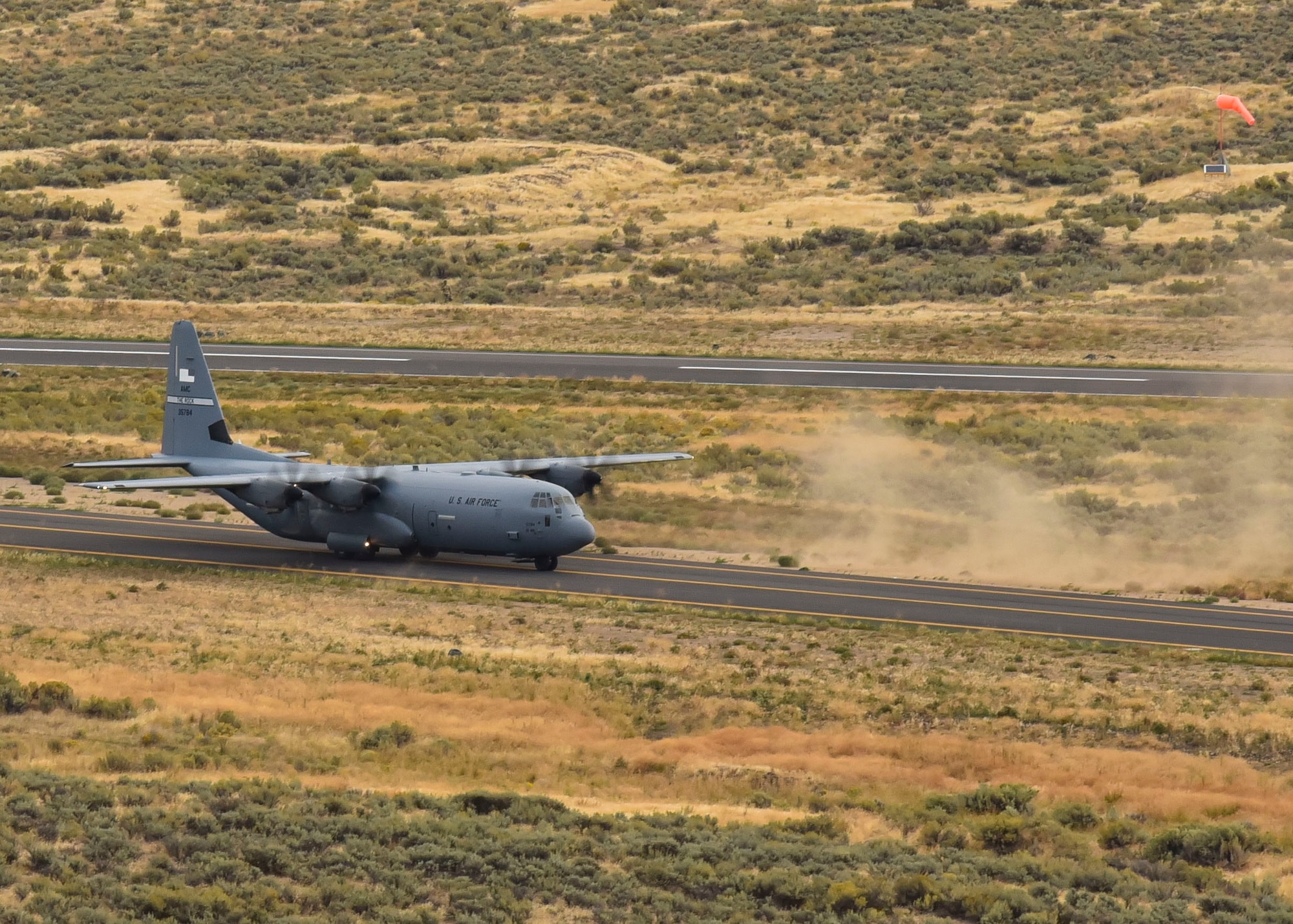 A U.S. Air Force C-130 Hercules from Little Rock Air Force Base, Arkansas, lands on a runway to deliver Humvees, cargo, and U.S. Air Force Airmen for a Joint Forcible Entry operation during Air Mobility Command’s Mobility Guardian exercise.
